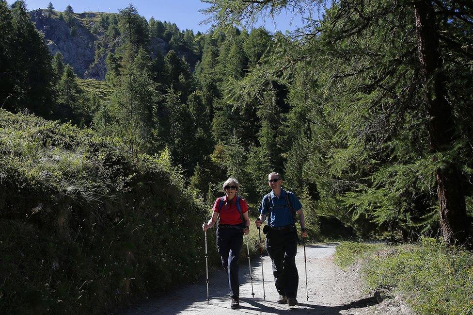 UK Prime Minister Theresa May walks with her husband Philip in Swiss Alps, 12 Aug 16