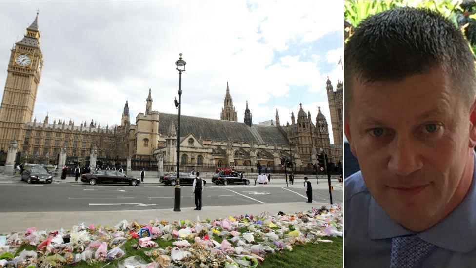 Flowers left outside the Houses of Parliament in honour of PC Keith Palmer and picture of PC Keith Palmer