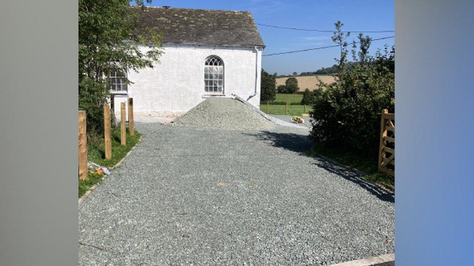 A mound of gravel outside the chapel