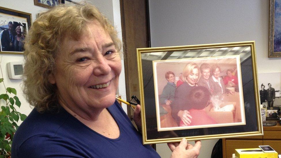 Zoe Lofgren holding a picture of Hillary Clinton