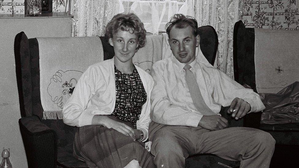 A couple sitting on the sofa