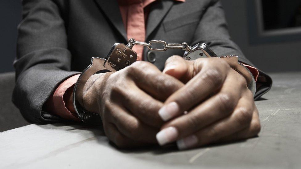 Black person in handcuffs