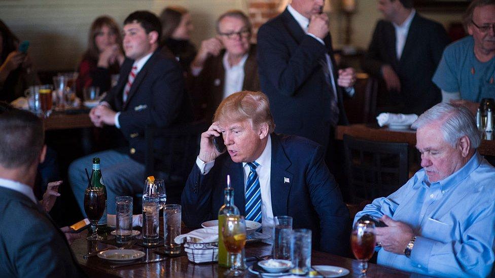 Donald Trump talking on his phone.