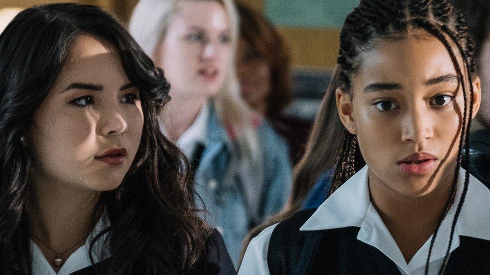 Amandla Stenberg (right) with another cast member in The Hate U Give