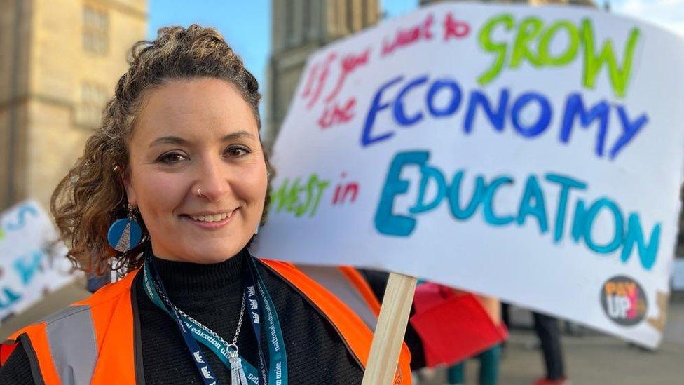 Rose Hawthorn, NEU Bristol, holding placard supporting teachers