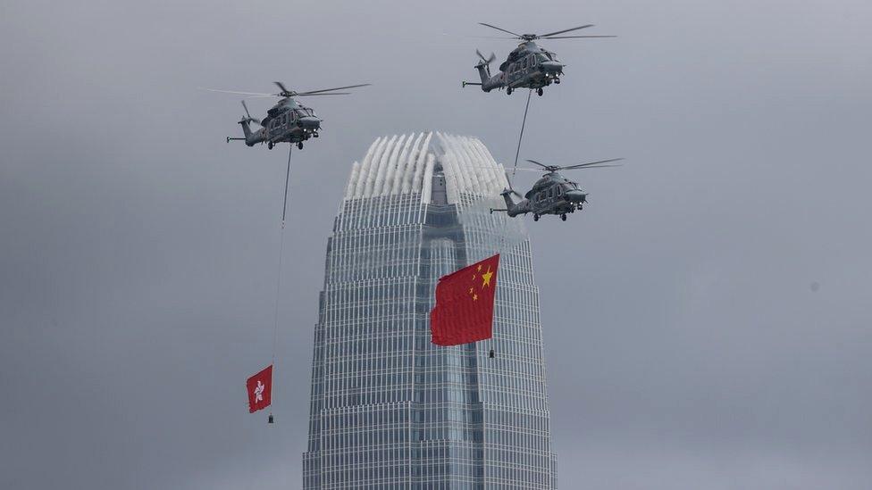 Government Flying Services aircrafts display the People's Republic of China and the Hong Kong SAR flags over the Convention Centre in Hong Kong, China, 01 July 2022