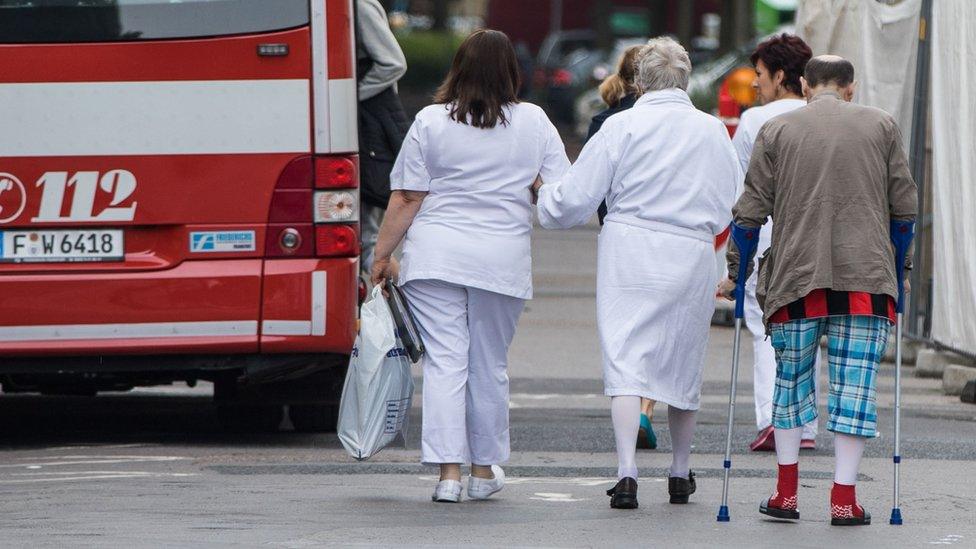 Elderly people getting on a bus