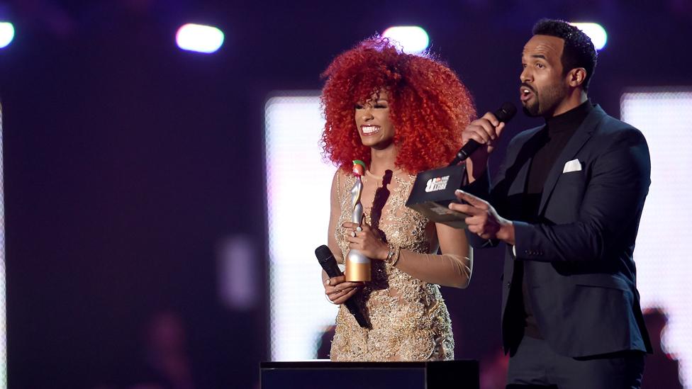 Craig David and Fleur East presenting an award at ceremony