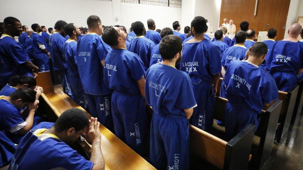 Inmates worship during Christmas Mass led by Archbishop Jose H. Gomez in a chapel at Men's Central Jail