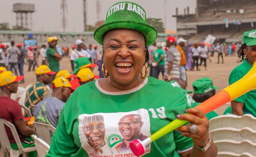 Woman wearing a hat that says Atiku Babes