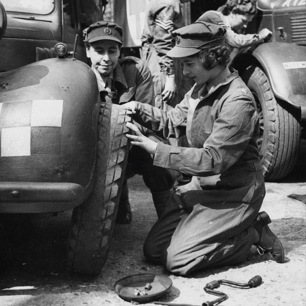 Princess Elizabeth, future queen Elizabeth II of England, learning how to change a car wheel as an auxiliary-officer of the English Army, 1945.