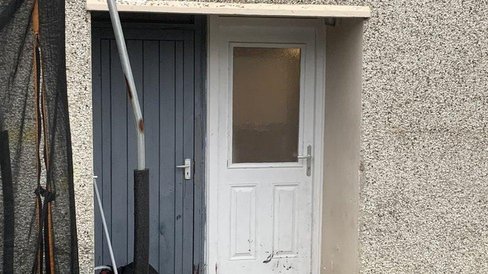 Damage caused to the back door of the house in Londonderry where the pipe bomb exploded