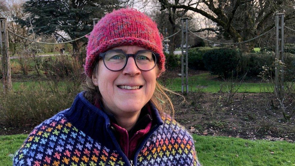 A woman in a red hat in the park