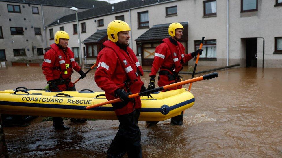 Coastguard rescue wade through waters in Brechin, Scotland