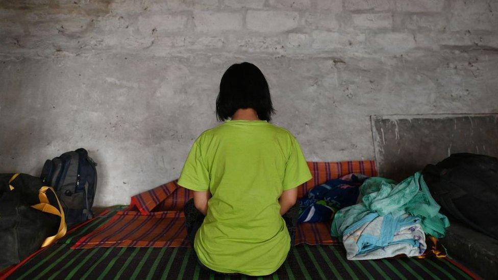 Burmese policewoman, who fled Myanmar and crossed illegally to India, rests in a temporary shelter at an undisclosed location in India's north-eastern state of Mizoram on March 13, 2021.