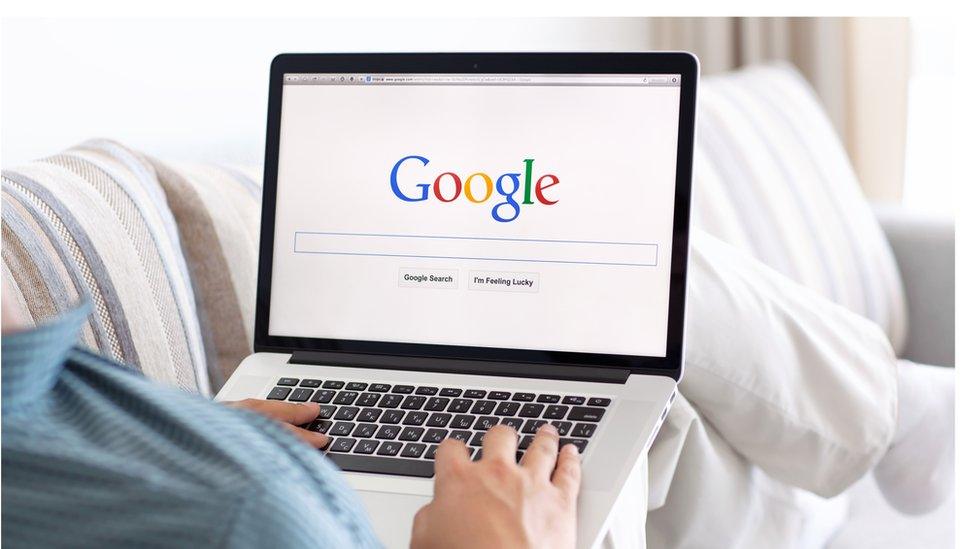 A laptop shows the Google search engine