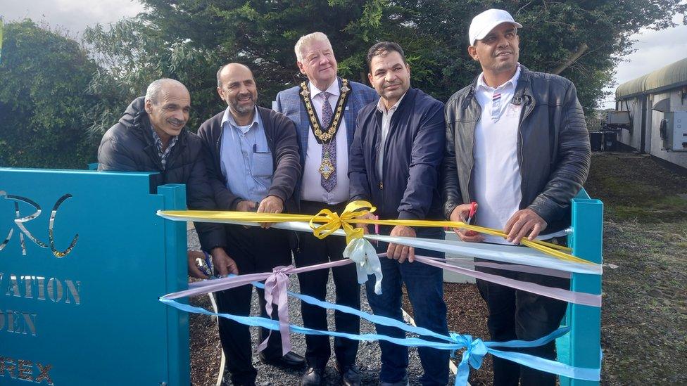 Syrian refugee volunteers at community garden