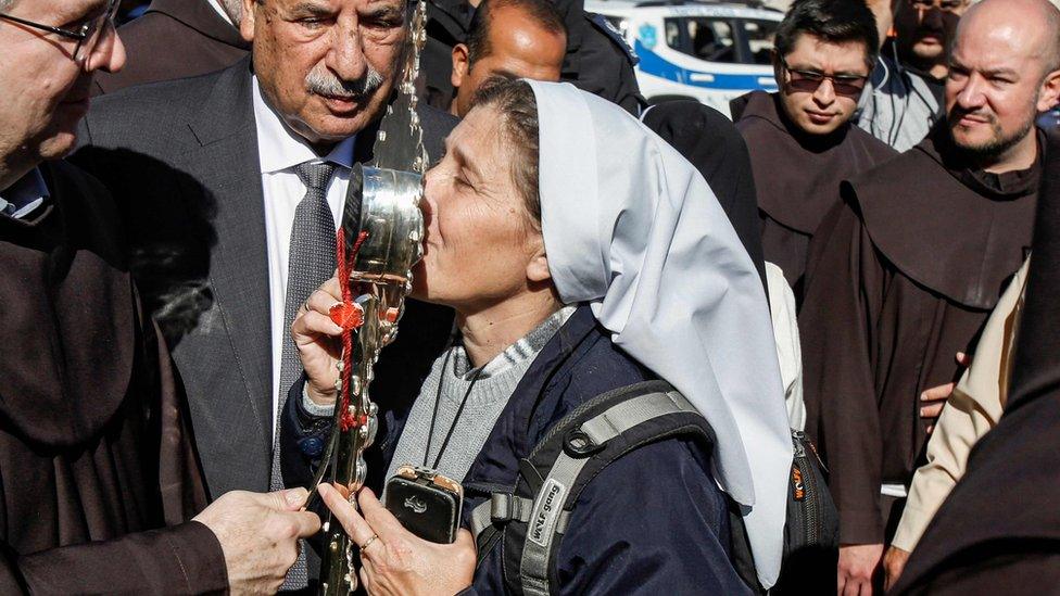 A nun kisses the relic during a procession in Bethlehem, 30 November 2019