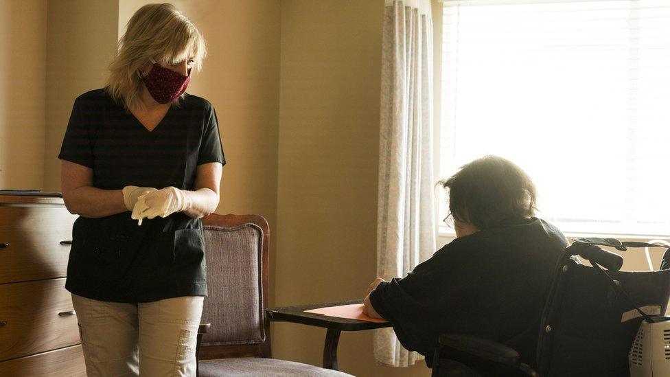 care home with masked worker