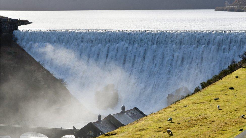 Water cascades over Caban Coch dam, near Rhayader in Powys