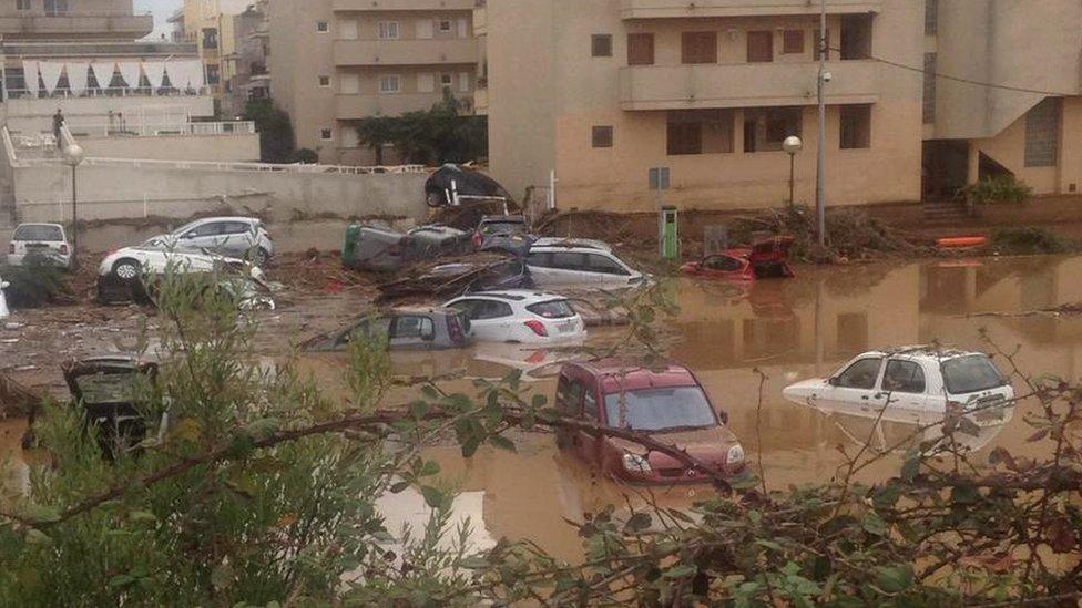 Cars were swept along by the floods in the town of Sa Coma, near S'illot on the Spanish island of Majorca