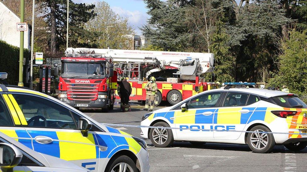 Road closed off by emergency vehicles