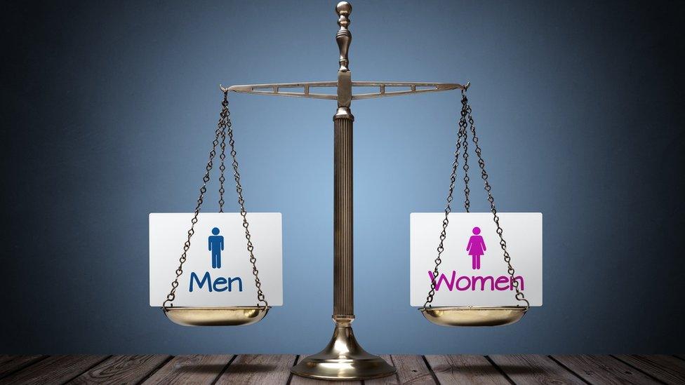 A set of scales representing men and women