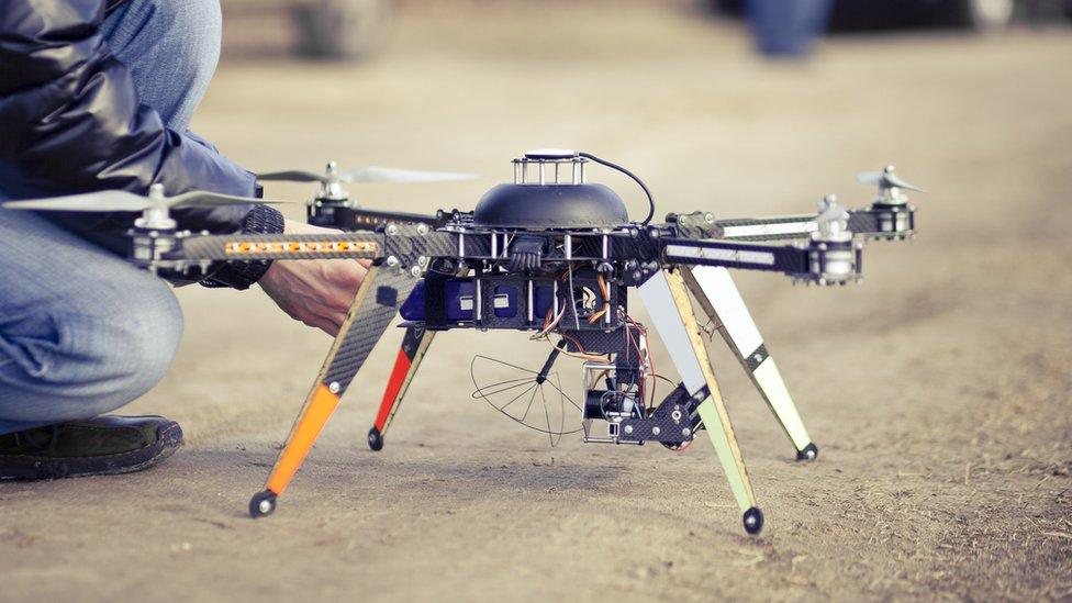 Man preparing a drone for filming