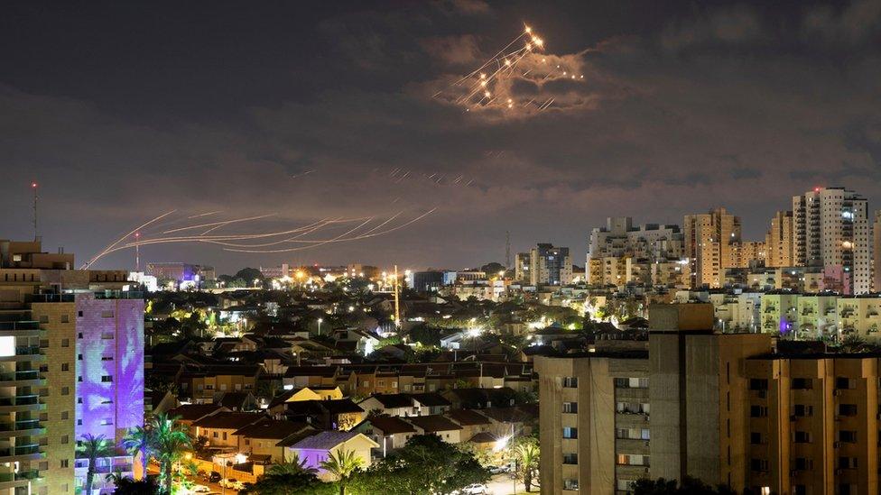 Streaks of light are seen as Israel's Iron Dome missile defence system intercepts rockets launched from the Gaza Strip towards Israel, as seen from Ashkelon, Israel (21 April 2022)