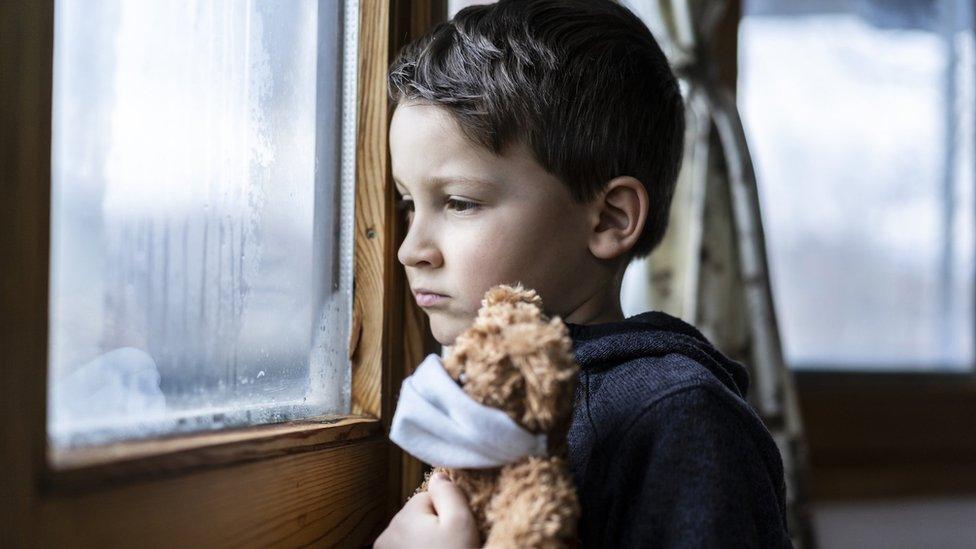 boy-looking-out-of-window.