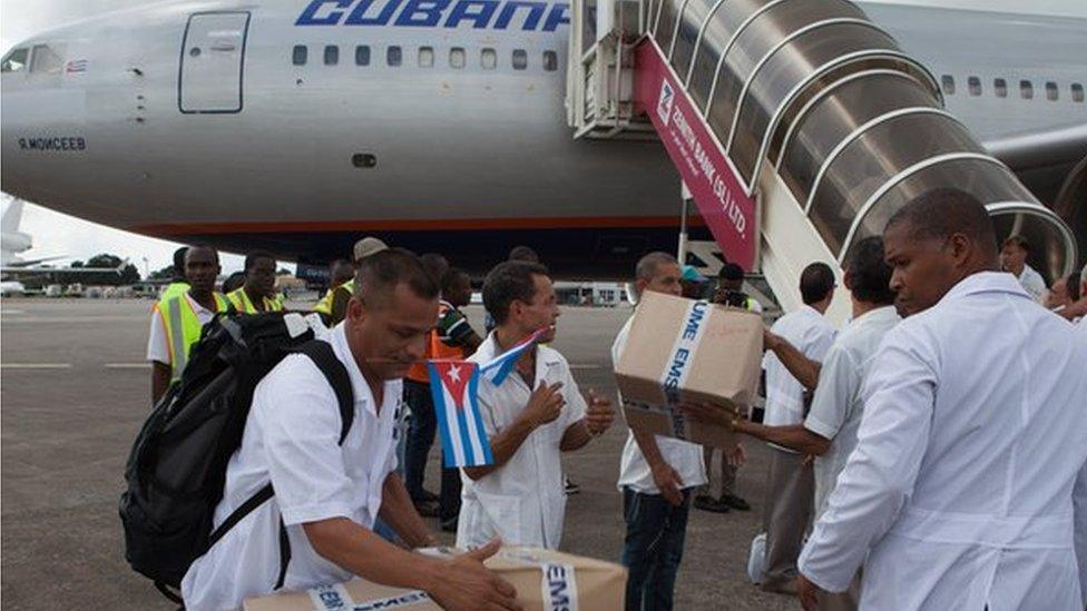 The first members of a team of 165 Cuban doctors and health workers upon their arrival at Freetown's airport to help the fight against Ebola in Sierra Leone, on 2 October, 2014.