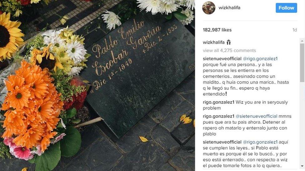 A screengrab from the Instagram account of Wiz Khalifa showing the grave of Pablo Escobar with flowers and a marijuana joint