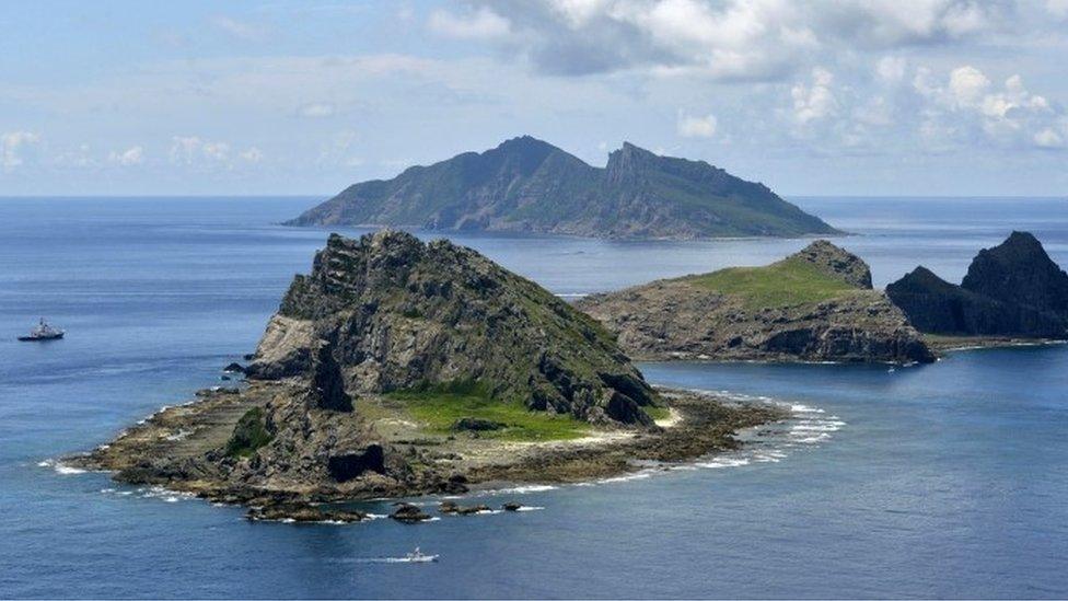 The survey ship Koyo Maru, left, chartered by Tokyo city officials, sails around Minamikojima, foreground, Kitakojima, middle right, and Uotsuri, background, the tiny islands in the East China Sea, called Senkaku in Japanese and Diaoyu in Chinese, Sunday, Sept. 2, 2012.