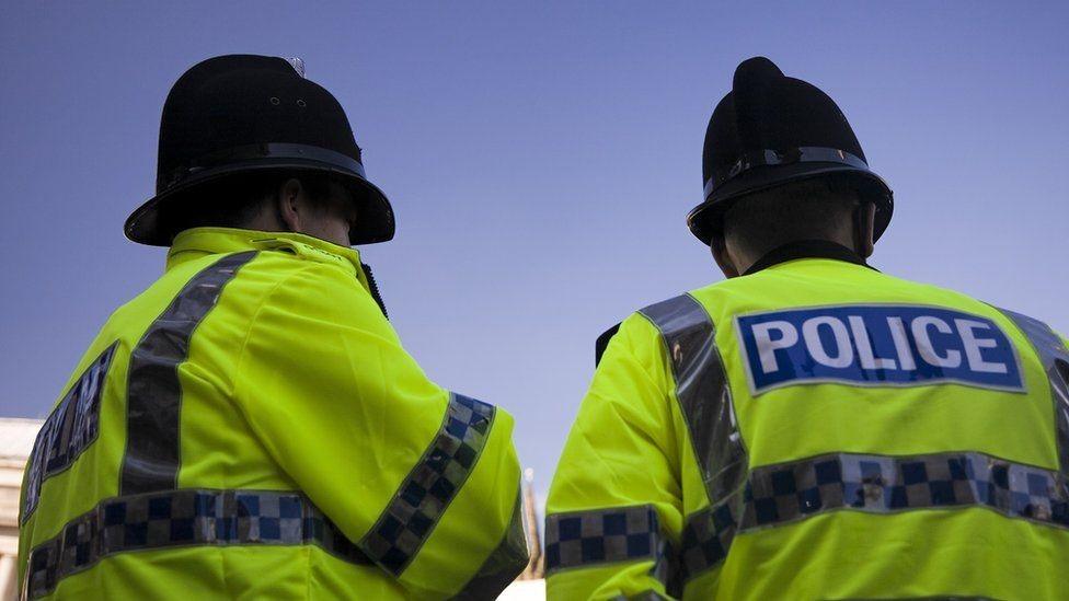 Two police officers in high vis police jackets