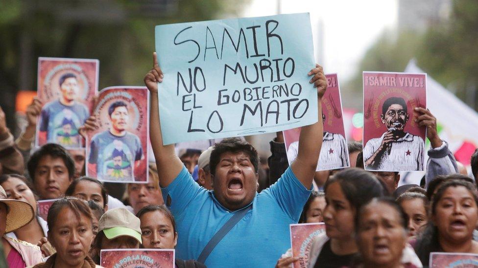 A man holds up a placard reading "Samir didn"t die, the government killed him" during a protest to demand justice for Mexican activist Samir Flores Soberanes in Mexico City, Mexico February 22, 2019