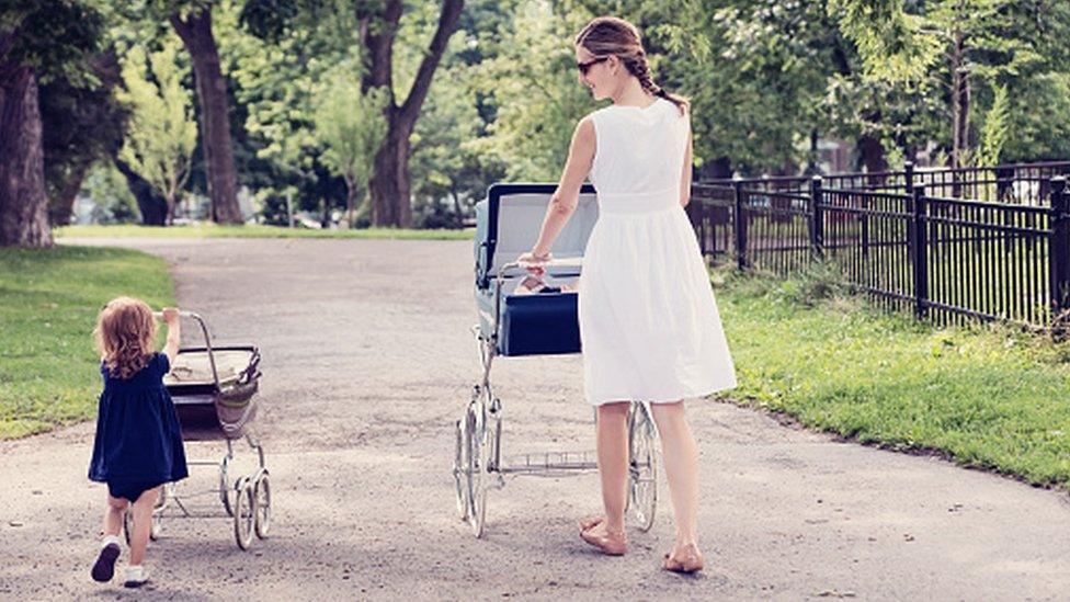 A woman and her daughter pushing prams