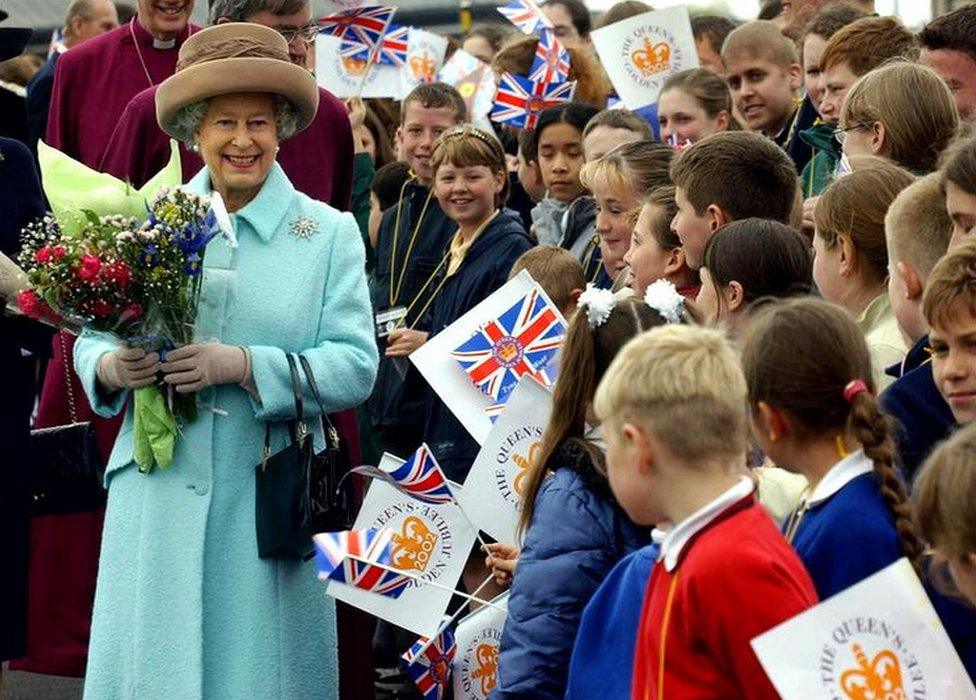 The Queen talks with a group of children after she had opened the Millennium Bridge between Newcastle and Gateshead on her visit to the North East on 7 May, 2002.