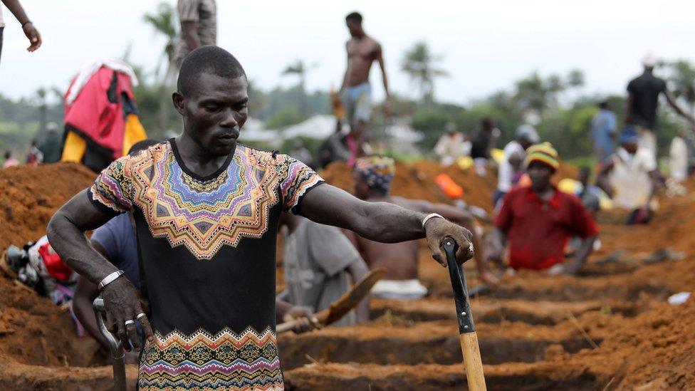 A worker is digging graves at the Paloko cemetery in Waterloo, Sierra Leone August 17, 2017. REUTERS