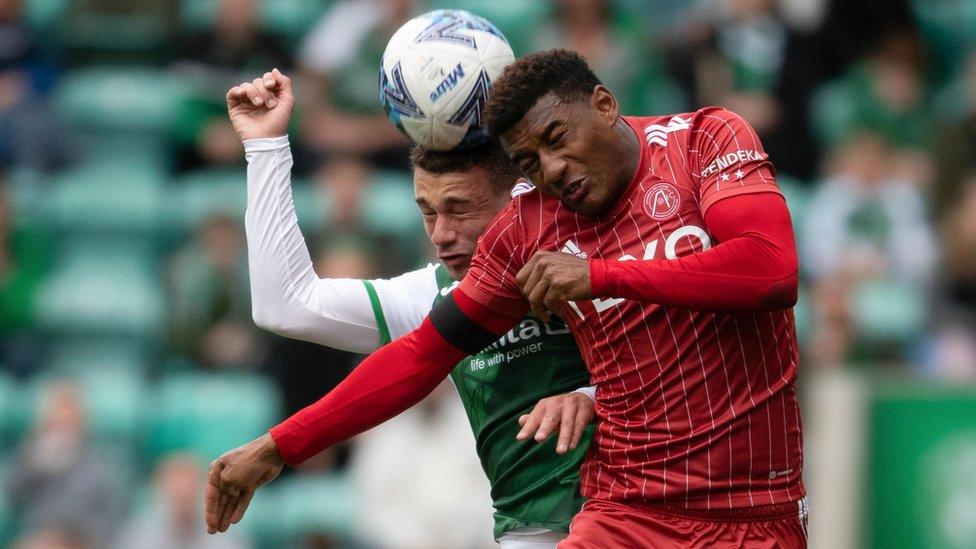 Aberdeen and Hibs players heading a ball