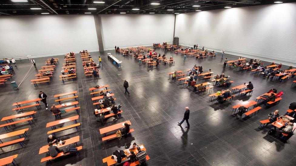 Evacuees wait in a local hall in Augsburg