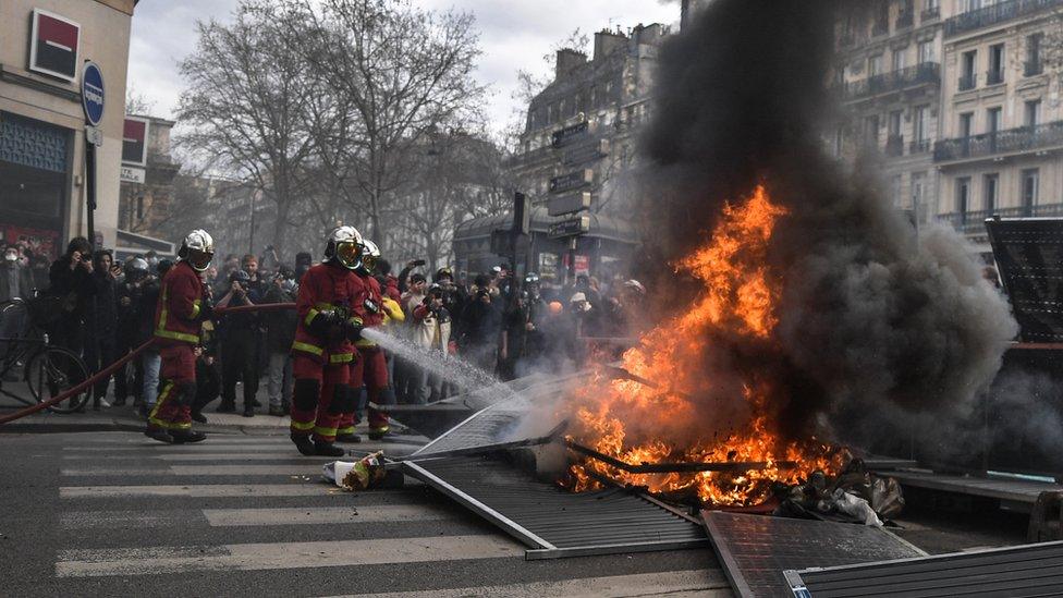 Firefighters work to put out fires in Paris