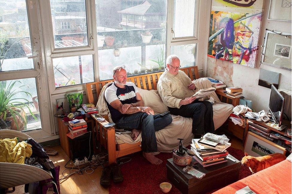 Two men in their living room