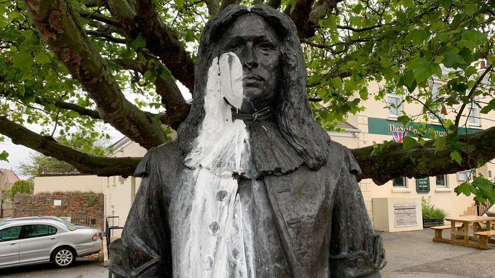 White paint on face and body of George Carteret statue