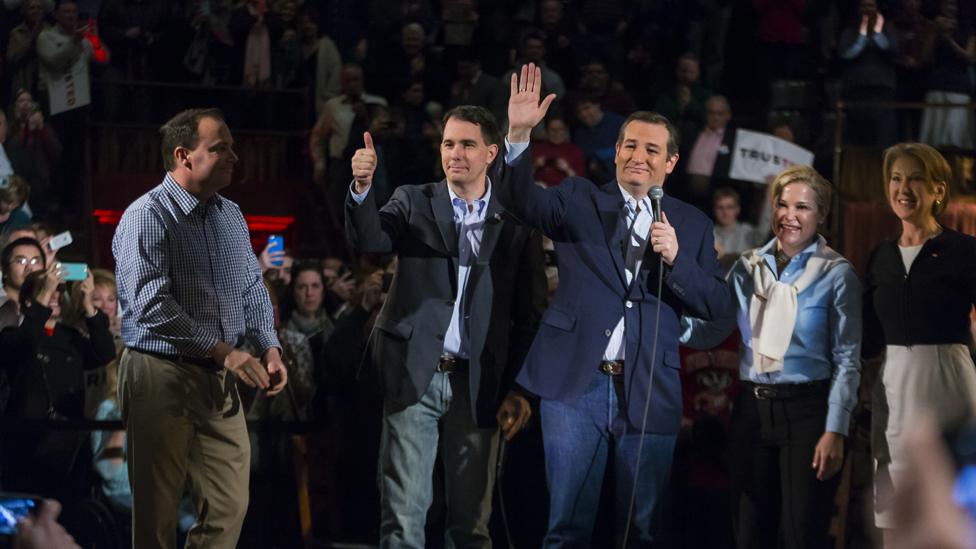 Republican presidential candidate, Sen. Ted Cruz, third from right, R-Texas, waves to the media after making a campaign stop along with Sen. Mike Lee, R-Utah, left, Wisconsin Gov. Scott Walker, Heidi Cruz and former presidential candidate Carly Fiorina Monday, April 4, 2016, in Madison, Wis.