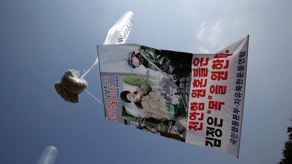 A balloon carrying leaflets, dollar notes and an anti-North poster