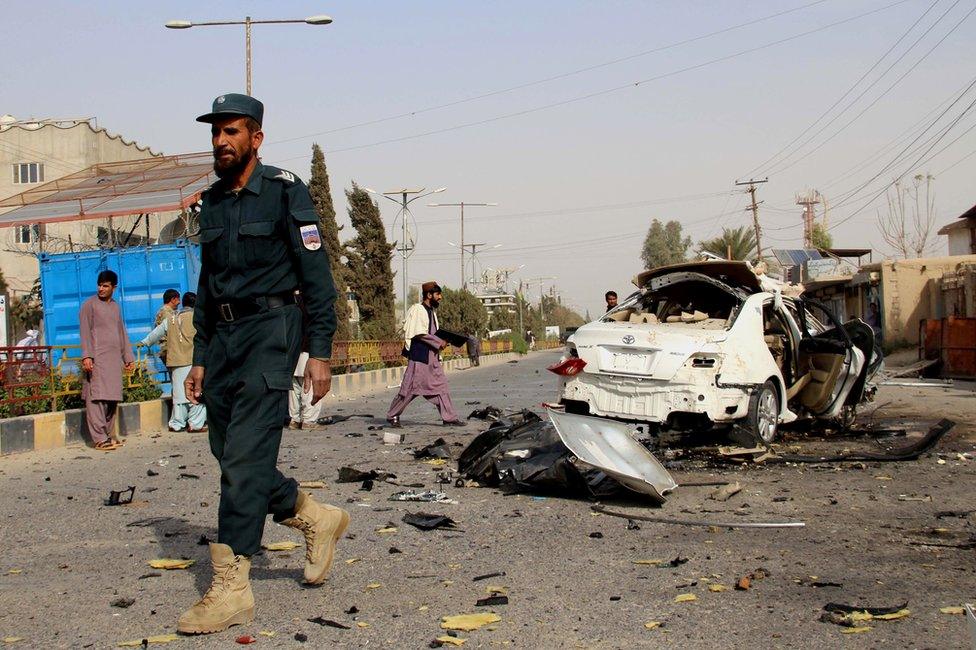 Afghan security officials inspect the scene of a IED blast in Lashkargah, the provincial capital of Helmand, Afghanistan, 12 November 2020.