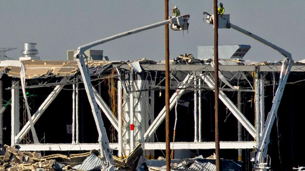 Amazon crew on lifts document the damage from the tornado that hit an Amazon distribution centre where the roof collapsed in Edwardsville, Illinois, US, on 13 December 2021