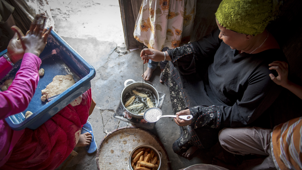 A woman cooking dumplings in Fort Dauphin, Madagascar