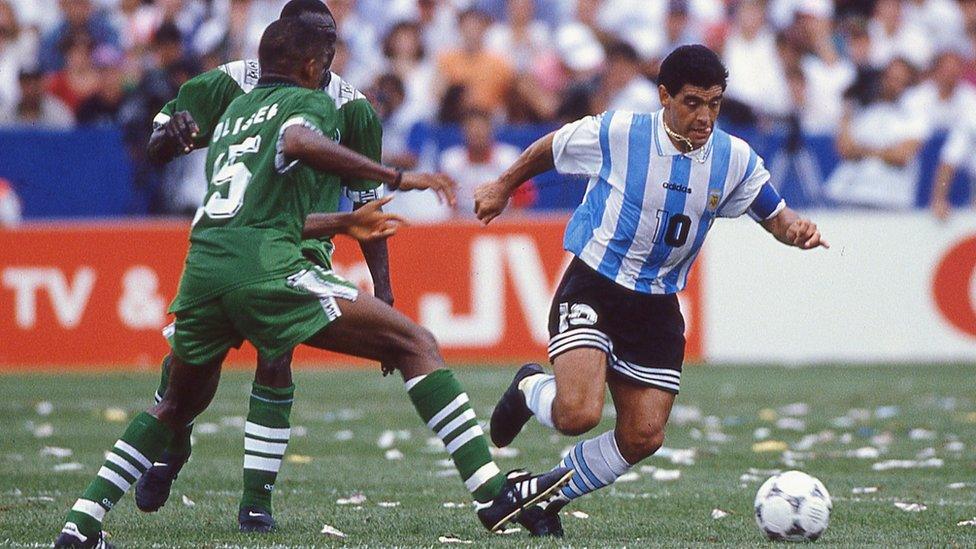 Diego Maradona moves the ball away from Sunday Oliseh