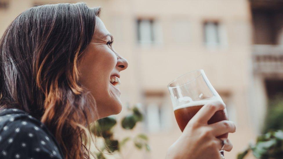 A woman drinking beer